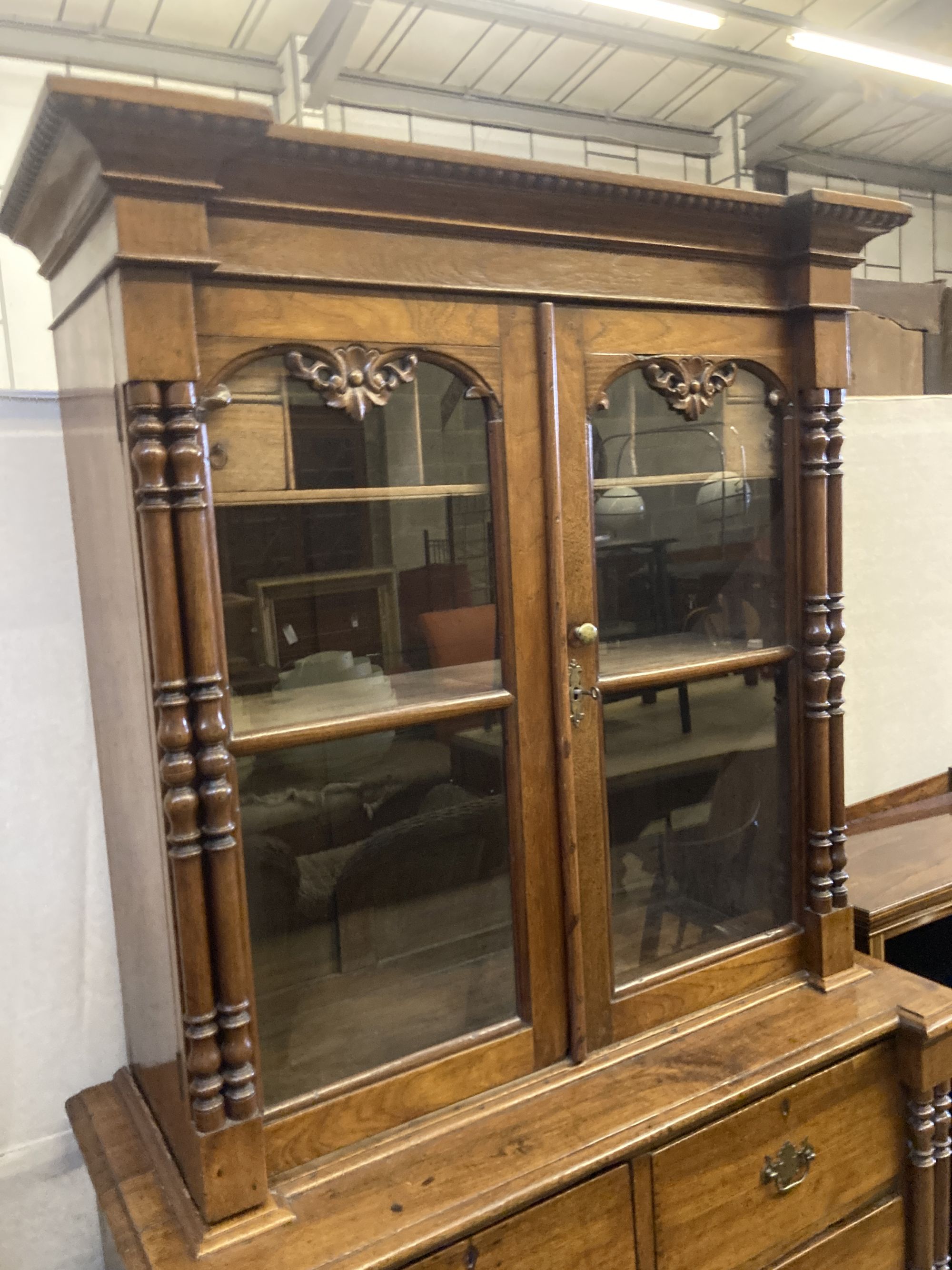 A 19th century Continental oak glazed cabinet on chest, width 104cm, depth 51cm, height 200cm